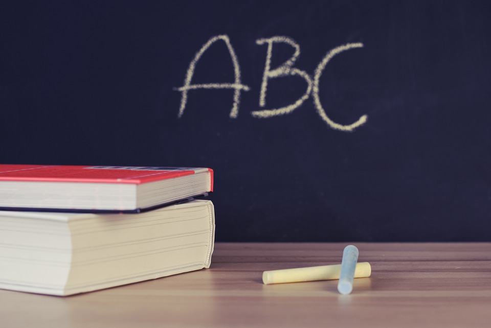 Classroom scene with blackboard, chalk and books
